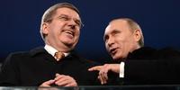 Russia's President Vladimir Putin (R) speaks with International Olympic Committee (IOC) President Thomas Bach during the Opening Ceremony of the Sochi Winter Olympics.(C)ANDREJ ISAKOVIC/AFP/Getty Images