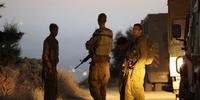 Israeli soldiers at a roadblock near where the bodies of the three abducted teenagers were found.(C)HAZEM BADER/AFP/Getty Images