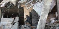 A member of the Palestinian Abu Lealla family examines the damage to his destroyed house following an Israeli airstrike north of Gaza City on, 11 July 2014.(C)EPA/MOHAMMED SABER