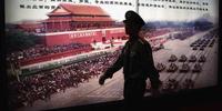 A guard passes by an exhibition board during the China International Exhibition and Symposium on Police Equipment Anti-Terrorism Technology and Equipment (CIPATE) in Beijing May 2009 © Feng Li/Getty AFP