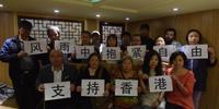 Beijing activists show support for democracy protests in Hong Kong on 29 September. The placards say 'Support Hong Kong' and 'embrace freedom in wind & rain'. 7 of this group remain in detention. (C) Private