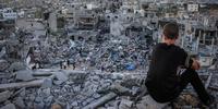 A Palestinian child sits above the ruins of his ruined home, and looks at thousands of homes destroyed because of the war on Gaza.(C)2014 Pacific Press