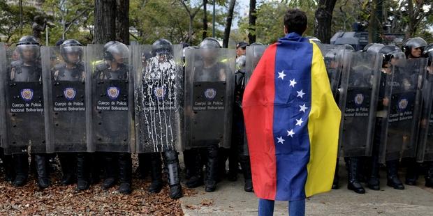 A police officer, a student and a third man died yesterday in separate incidents in Venezuela.(C)LEO RAMIREZ/AFP/Getty Images 