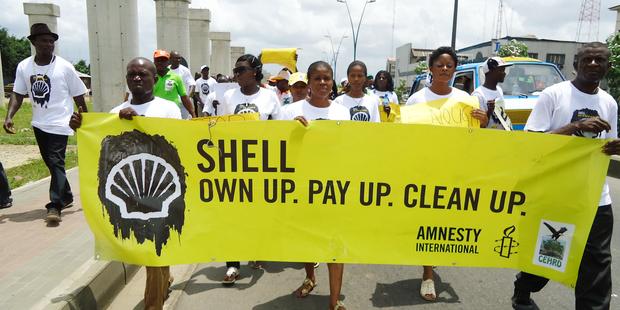 Activists in Port Harcourt, Nigeria protest to demand that Shell pay reparations and clean up its oil spills. 