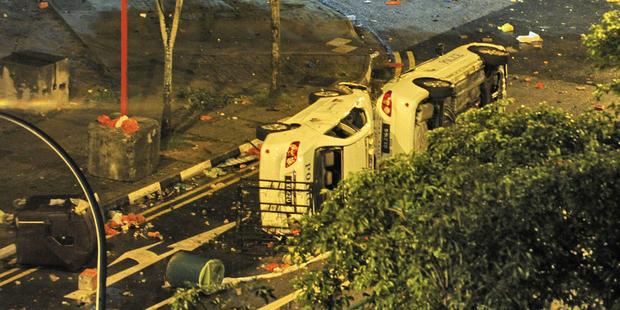 Several vehicles were burnt out or damaged during Singapore's worst rioting for four decades. (C) AFP/Getty Images