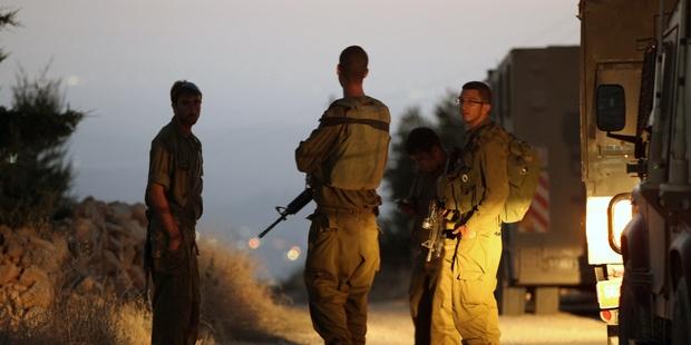 Israeli soldiers at a roadblock near where the bodies of the three abducted teenagers were found.(C)HAZEM BADER/AFP/Getty Images