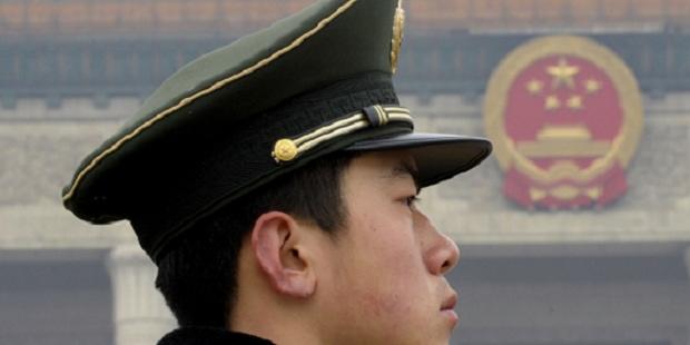 A Chinese paramilitary policeman stands guard on Tiananmen Square(C) AI