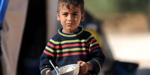 A Syrian boy looks on in a newly built refugee camp.(c)AFP/Getty Images