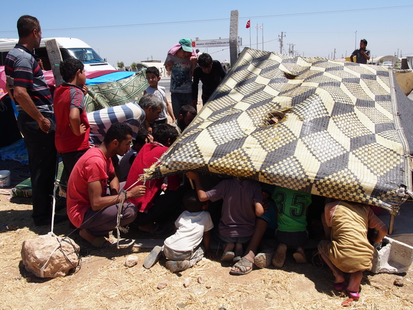 Syrians trying to get into the Turkish government-run refugee camp in Akçakale, near the Syrian border. There was no room for them, so they had been waiting outside for weeks or months.