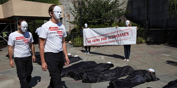 Activists in bodybags outside the UN building in New York have called for a strong arms trade treaty.© Control Arms Coalition/Andrew Kelly